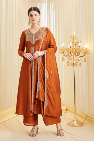 Model wearing a premium orange silk embroidered Anarkali kurta featuring a V-neck and full sleeves, paired with a matching dupatta, perfect for festive wear and weddings.