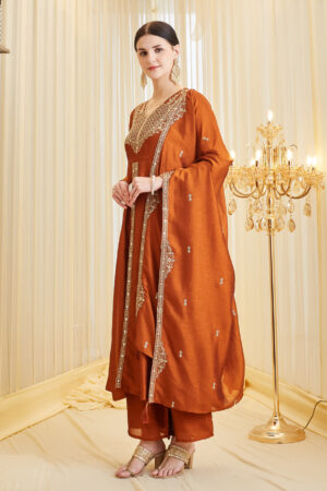 Model wearing a premium orange silk embroidered Anarkali kurta featuring a V-neck and full sleeves, paired with a matching dupatta, perfect for festive wear and weddings.