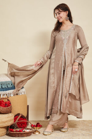 Model wearing a luxurious grey embroidered silk Anarkali kurta featuring a round neck and full sleeves, paired with a matching dupatta for weddings and festive occasions.