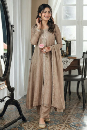 Model wearing a luxurious grey embroidered silk Anarkali kurta featuring a round neck and full sleeves, paired with a matching dupatta for weddings and festive occasions.