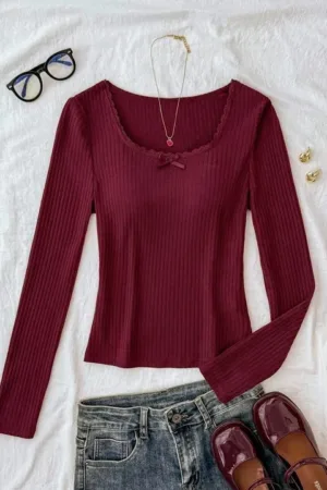 Close up of textured stretchable fabric and lace trim on Sona Mart women's top