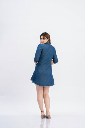 Full length view of women's casual denim tunic dress with frayed hem.