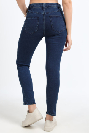Full length view of stretchable ankle-length indigo jeans for women.
