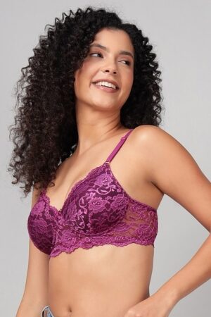 Close up of exquisite lace and central bow on a wine-colored bra.