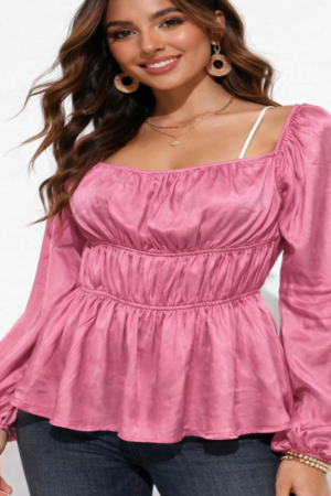 Full length view of stylish pink peplum top paired with denim.