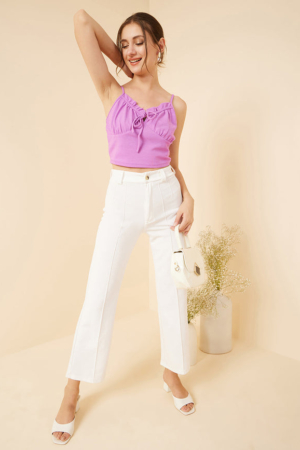 Close up of sweetheart neckline and thin shoulder straps on a lavender top.