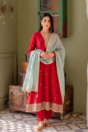 Woman wearing Sona Mart premium red embroidered silk Anarkali set with contrasting pastel dupatta.