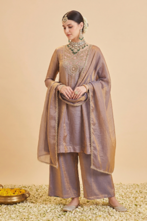 Woman wearing Sona Mart premium purple silk embroidered Anarkali set.