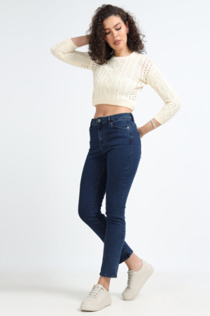 Close up of 5-pocket design and button closure on dark blue denims.