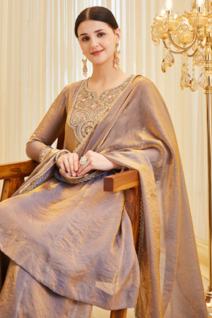 Woman wearing Sona Mart premium purple silk embroidered Anarkali set.