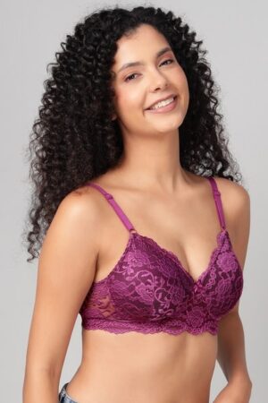 Close up of exquisite lace and central bow on a wine-colored bra.
