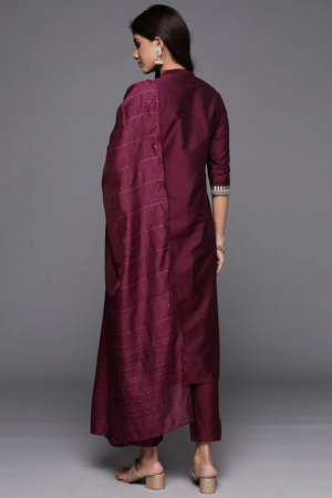 Close up of intricate Zari embroidery and mandarin collar on a wine silk kurta.