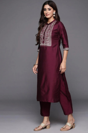Close up of intricate Zari embroidery and mandarin collar on a wine silk kurta.